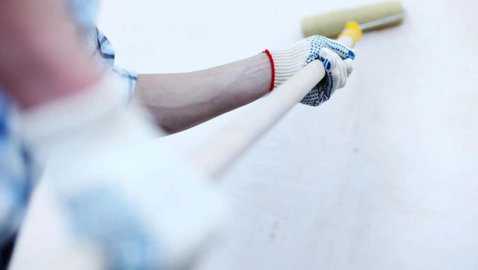 A person holding a baseball bat with a yellow handle.